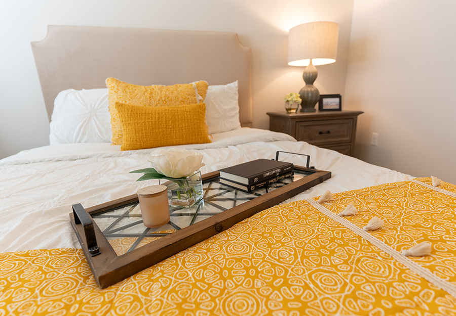 Close-up of bed with yellow accents