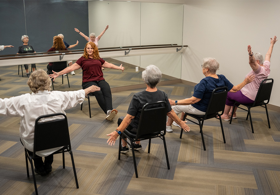seniors participating in group seated exercise class