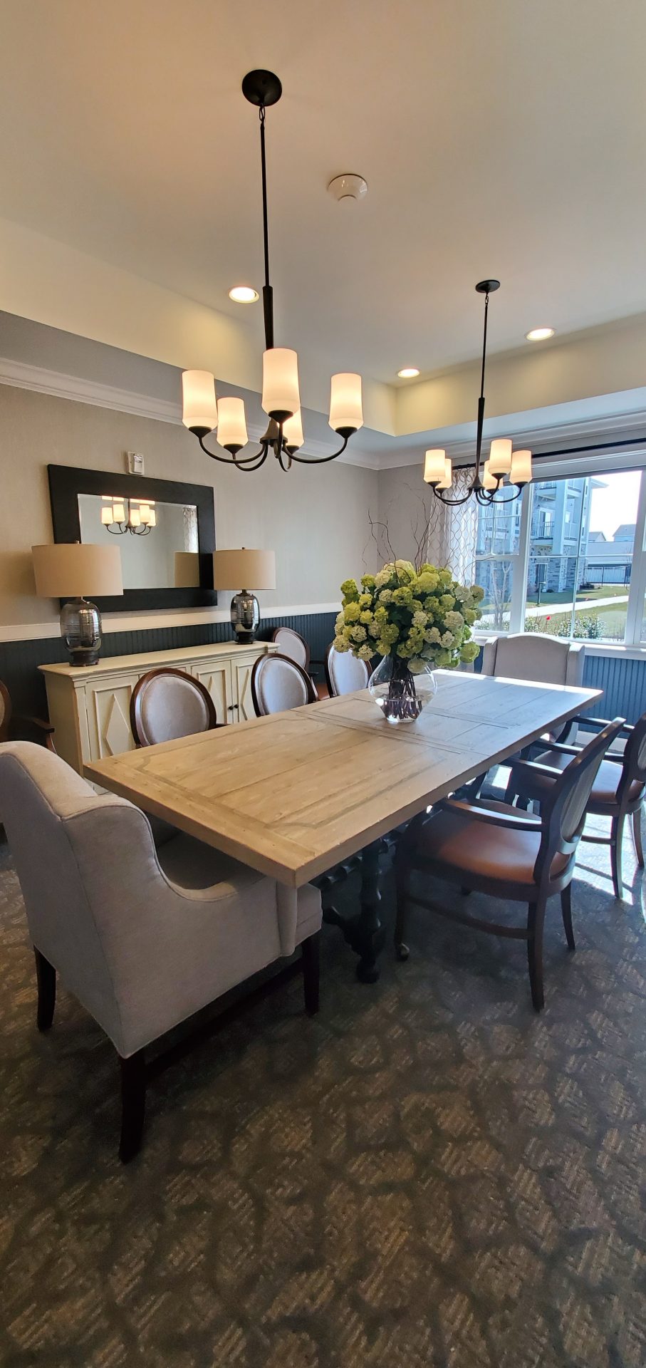 Elegant Private Dining Room Elegantly designed private dining room with a large table, upholstered chairs, and decorative lighting.