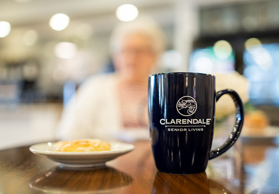 close-up-of-breakfast-and-coffee-mug Close up of Clarendale of St Peters mug on table next to small plate of breakfast