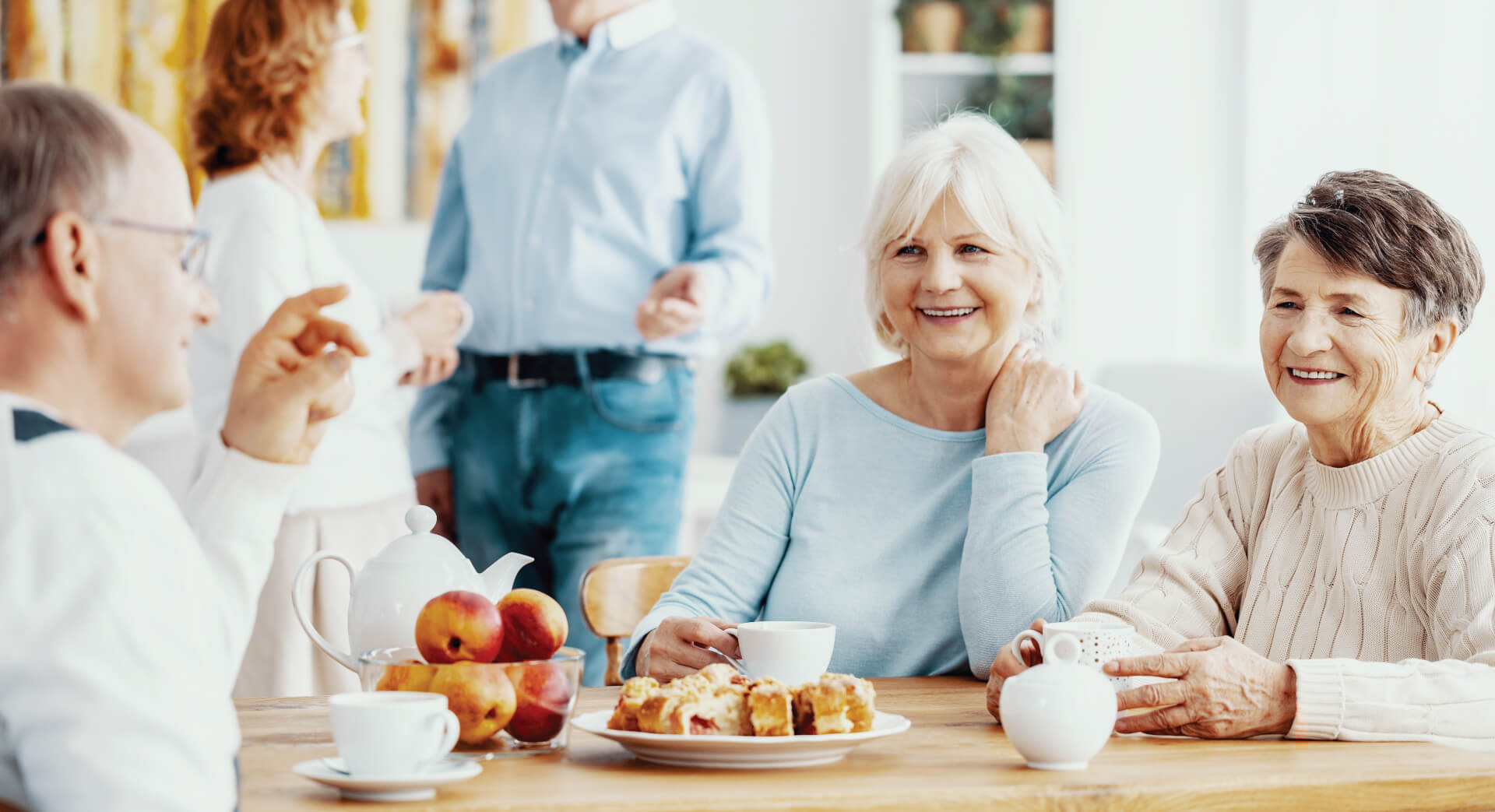 Senior friends around a table drinking coffee