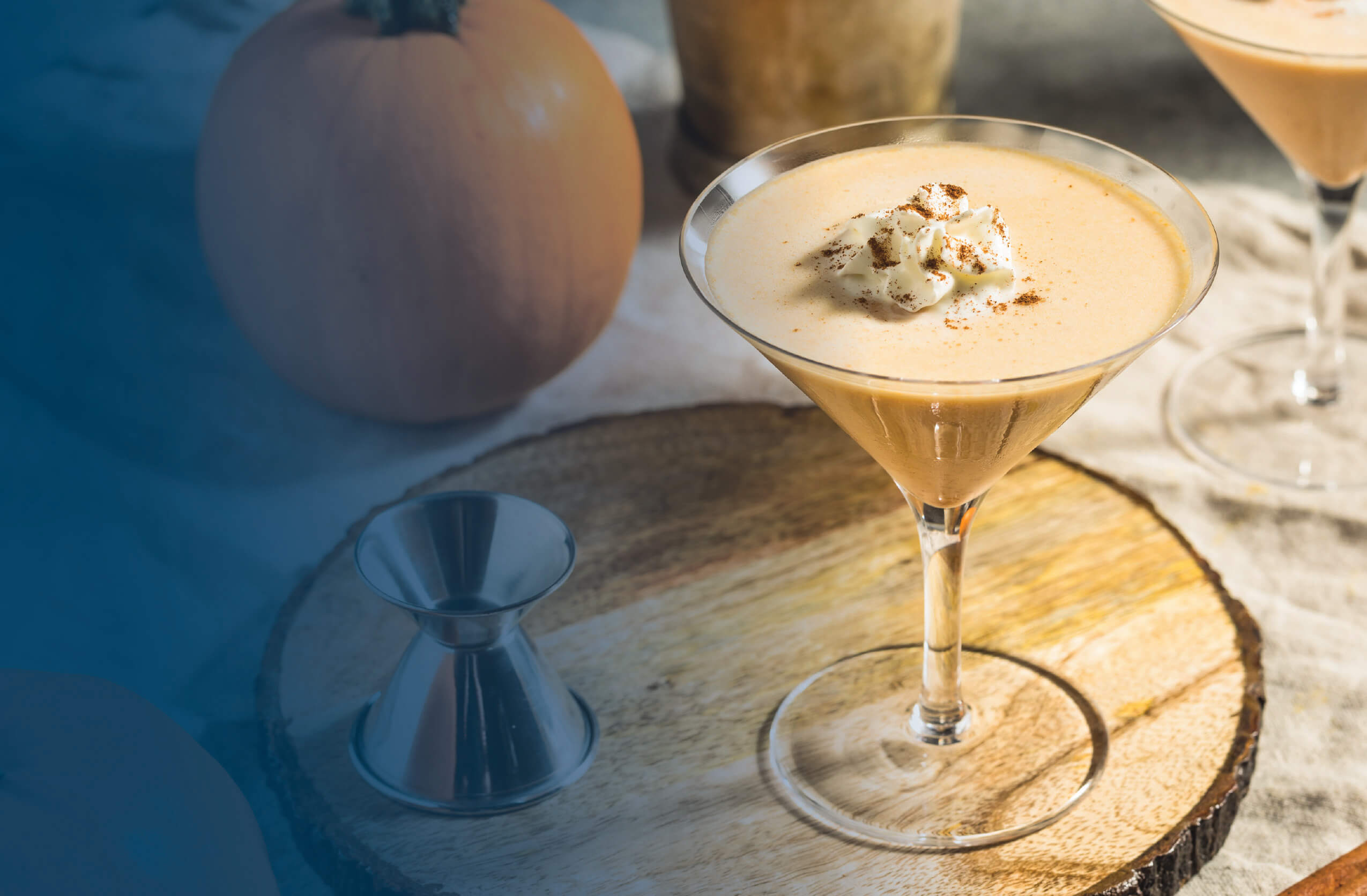 Pumpkin cocktail on wooden slab with pumpkin